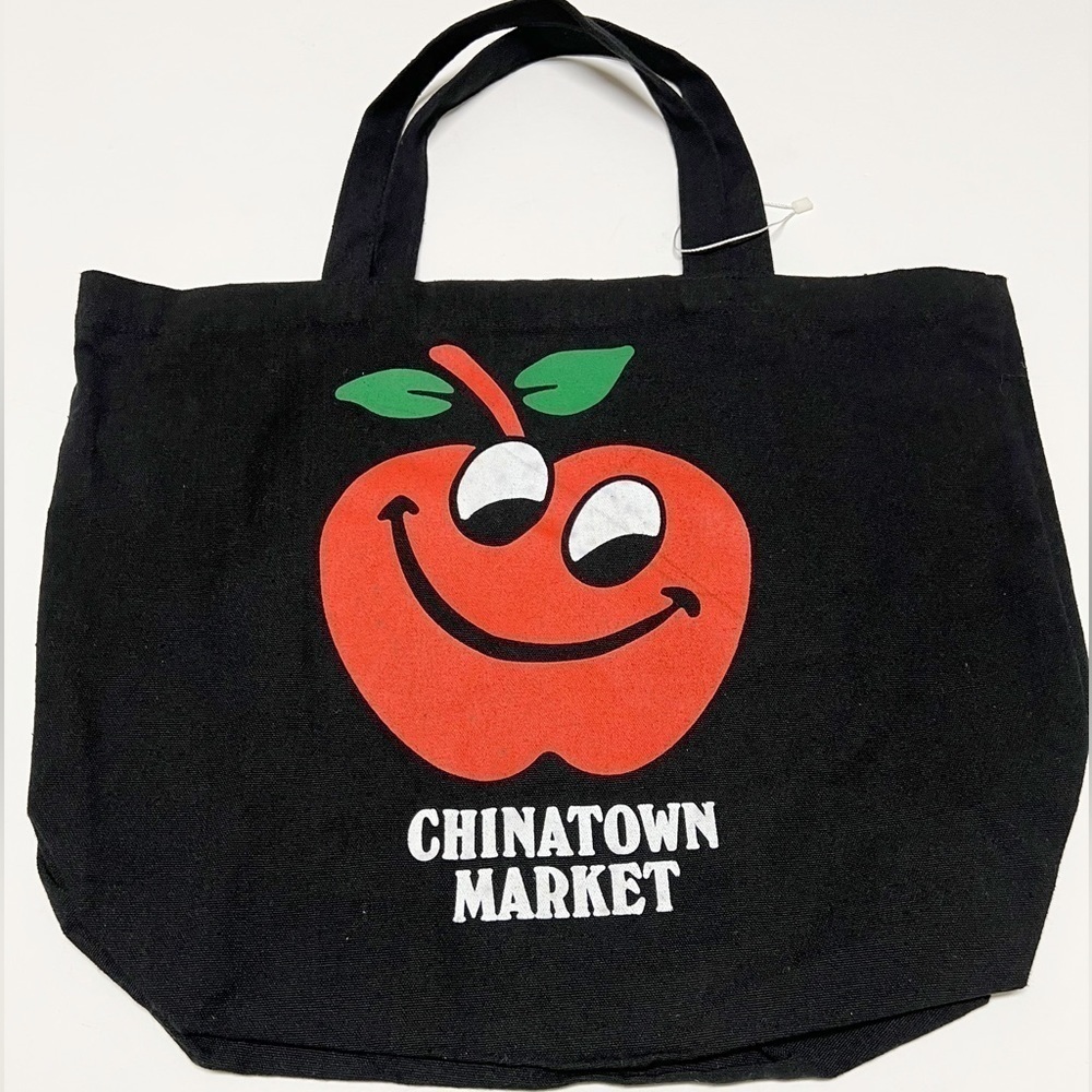 Chinatown Market Unisex Black Cotton Canvas Large Grinning Apple Print Tote Bag